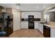 Modern kitchen with white cabinets, sleek black appliances and tiled backsplash at 10666 Cherry Ridge Ct, Las Vegas, NV 89129