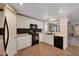 Charming kitchen featuring white cabinetry, black appliances, and a stylish backsplash at 10666 Cherry Ridge Ct, Las Vegas, NV 89129
