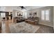 Comfortable living room featuring neutral walls, tiled floors, and a plush sofa set on a decorative rug at 10666 Cherry Ridge Ct, Las Vegas, NV 89129