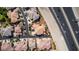 Aerial view of a condo complex near a highway, with the unit highlighted in brown for emphasis at 10809 Garden Mist Dr # 2050, Las Vegas, NV 89135