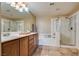 Bright bathroom with double vanity, soaking tub, and glass-enclosed shower offering a spa-like experience at 10809 Garden Mist Dr # 2050, Las Vegas, NV 89135