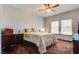 Bedroom with plush carpeting, windows and a ceiling fan, alongside modern furnishings at 10809 Garden Mist Dr # 2050, Las Vegas, NV 89135