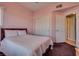 Cozy bedroom features soft pink walls, plush carpeting, and a comfortable queen-size bed at 10809 Garden Mist Dr # 2050, Las Vegas, NV 89135