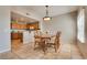 Lovely dining area with adjacent kitchen, tile flooring, and decorative lighting at 10809 Garden Mist Dr # 2050, Las Vegas, NV 89135