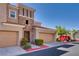 Attractive townhome boasting stone accents, manicured shrubs, two-car garage, and inviting curb appeal at 10809 Garden Mist Dr # 2050, Las Vegas, NV 89135