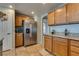 Kitchen area featuring stainless steel fridge, wine glasses and granite countertops at 10809 Garden Mist Dr # 2050, Las Vegas, NV 89135