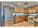 Kitchen featuring tile floors, cabinets, granite countertops, and stainless steel appliances at 10809 Garden Mist Dr # 2050, Las Vegas, NV 89135