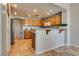 Kitchen featuring wooden cabinets, breakfast bar and tile flooring with stainless appliances at 10809 Garden Mist Dr # 2050, Las Vegas, NV 89135