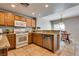 Well lit kitchen with granite countertops, stainless steel appliances, and tile flooring at 10809 Garden Mist Dr # 2050, Las Vegas, NV 89135