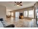 Bright, open living room with tile flooring, cozy fireplace, and sliding glass door to outdoor space at 10809 Garden Mist Dr # 2050, Las Vegas, NV 89135