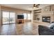 Spacious living room with neutral colors, tiled floors, fireplace and sliding glass door to the balcony at 10809 Garden Mist Dr # 2050, Las Vegas, NV 89135