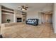 Spacious living room with tile flooring, fireplace, ceiling fan, and nice natural lighting at 10809 Garden Mist Dr # 2050, Las Vegas, NV 89135