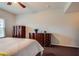 Cozy bedroom featuring stylish dark wood furniture, soft lighting, and a comfortable bed at 10809 Garden Mist Dr # 2050, Las Vegas, NV 89135