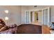 Home office with glass french doors opening to tile hallway, features a recliner at 10809 Garden Mist Dr # 2050, Las Vegas, NV 89135
