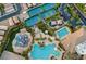 An aerial view shows community amenities including tennis courts, a pool, and a water park at 115 Cora Hills Ct, Las Vegas, NV 89148