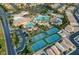 The aerial view displays community amenities: tennis courts, pools, a water park, and clubhouse areas at 115 Cora Hills Ct, Las Vegas, NV 89148