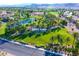 Scenic aerial view of the Rhodes Ranch community featuring a pond, golf course, and lush landscaping at 115 Cora Hills Ct, Las Vegas, NV 89148