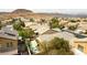 This aerial shot captures a neighborhood with desert landscaping, pools, and mountain views at 115 Cora Hills Ct, Las Vegas, NV 89148