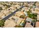 This aerial shows a neighborhood with pools, solar panels, and desert landscaping at 115 Cora Hills Ct, Las Vegas, NV 89148