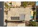 Aerial view features houses with backyard pools, solar panels and desert landscaping at 115 Cora Hills Ct, Las Vegas, NV 89148
