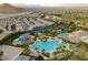Spectacular aerial view of the community amenities featuring a pool, waterslide, and lush landscaping at 115 Cora Hills Ct, Las Vegas, NV 89148