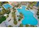 Stunning aerial view of the community pool featuring multiple pools, palm trees, and lounge areas at 115 Cora Hills Ct, Las Vegas, NV 89148