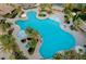 Expansive community pool and deck area, perfect for relaxation and social gatherings with palm trees at 115 Cora Hills Ct, Las Vegas, NV 89148