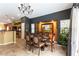 A cozy dining room with stylish chandelier, view into kitchen, and outdoor access at 115 Cora Hills Ct, Las Vegas, NV 89148