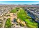 Picturesque aerial view of the golf course at Rhodes Ranch with sand traps and manicured greens at 115 Cora Hills Ct, Las Vegas, NV 89148