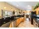 Open kitchen features granite countertops, tile floors, stainless steel appliances, and pendant lighting at 115 Cora Hills Ct, Las Vegas, NV 89148