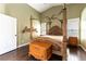 Charming main bedroom with canopy bed, hardwood floors, and serene ambiance for restful nights at 115 Cora Hills Ct, Las Vegas, NV 89148