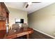 An office with hardwood floors, a desk, relaxing seating and a large window at 115 Cora Hills Ct, Las Vegas, NV 89148