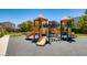 Community playground and recreational area with slides, swings, and shade structures at 115 Cora Hills Ct, Las Vegas, NV 89148