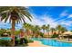 Resort style community pool area with waterslides, palm trees and lounge chairs at 115 Cora Hills Ct, Las Vegas, NV 89148
