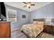 Cozy bedroom with wood-look floors, ceiling fan, and floral bedding set at 1152 Pine Cove Ct, Henderson, NV 89011