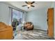 Bedroom with light blue walls, wood-look floors, a window, and a chair with a desk at 1152 Pine Cove Ct, Henderson, NV 89011