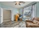 Bedroom with light blue walls, wood-look floors, a window, and a chair with a desk at 1152 Pine Cove Ct, Henderson, NV 89011