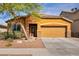 Charming single-story home featuring a two car garage and a desert landscape with a lovely tree in the front yard at 1152 Pine Cove Ct, Henderson, NV 89011