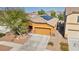 Single Gathering home featuring a two-car garage, desert landscaping and solar panels at 1152 Pine Cove Ct, Henderson, NV 89011
