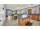 Open concept kitchen and dining area with tile floors, stainless steel appliances, an island and access to backyard at 1152 Pine Cove Ct, Henderson, NV 89011