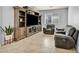 Cozy living room with tile floors, gray walls, entertainment center, and two reclining chairs at 1152 Pine Cove Ct, Henderson, NV 89011