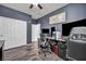 Office with dark walls, wood-look floors, large desk and dual monitors at 1152 Pine Cove Ct, Henderson, NV 89011