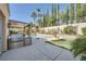 This backyard features a covered patio, outdoor kitchen, pool, and lounge chairs for outdoor relaxation at 11540 Snow Creek Ave, Las Vegas, NV 89135