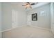 This bedroom has neutral carpeting, a ceiling fan, and a single window for natural light at 11540 Snow Creek Ave, Las Vegas, NV 89135