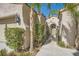Close-up of the home's stucco exterior, showing the private gated entrance and desert landscaping at 11540 Snow Creek Ave, Las Vegas, NV 89135