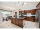Well-equipped kitchen with dark wood cabinetry, granite countertops, and stainless steel appliances at 11540 Snow Creek Ave, Las Vegas, NV 89135