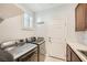 This laundry room features front loading washer and dryer plus storage cabinets and a tiled floor at 11540 Snow Creek Ave, Las Vegas, NV 89135