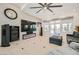 Modern living room featuring a decorative fireplace, large TV, and access to outdoor patio at 11540 Snow Creek Ave, Las Vegas, NV 89135