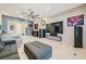 Modern living room featuring a decorative fireplace, large TV, and comfortable seating arrangements at 11540 Snow Creek Ave, Las Vegas, NV 89135
