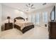 Large main bedroom with neutral tones, ceiling fan and private entry to the patio at 11540 Snow Creek Ave, Las Vegas, NV 89135
